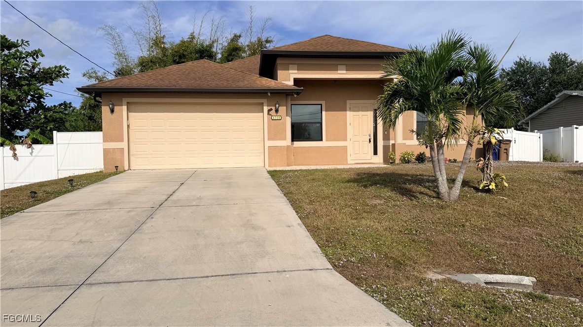 4310 4th Street Southwest Lehigh Acres, FL 33976 - Photo 2 of 27 a view of a house with a yard and potted plants