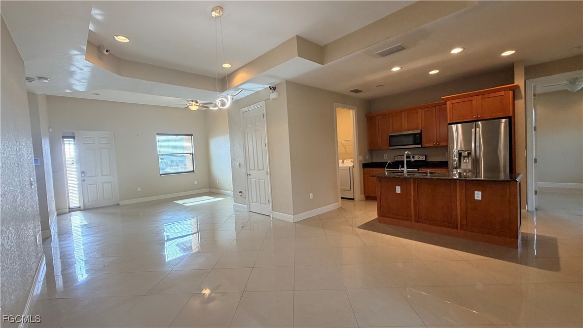 4310 4th Street Southwest Lehigh Acres, FL 33976 - Photo 5 of 27 a view of a kitchen with refrigerator and windows