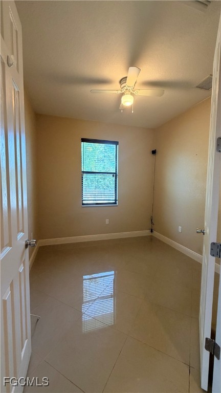 4310 4th Street Southwest Lehigh Acres, FL 33976 - Photo 10 of 27 an empty room with windows and ceiling fan