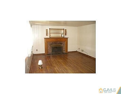603 A Old Post Road Edison, NJ 08817 - Photo 2 of 9 a picture of a living room with a fireplace