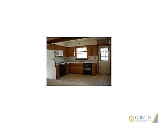 603 A Old Post Road Edison, NJ 08817 - Photo 4 of 9 a hallway with a large window and kitchen view