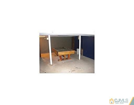603 A Old Post Road Edison, NJ 08817 - Photo 8 of 9 a living room with furniture and a chair