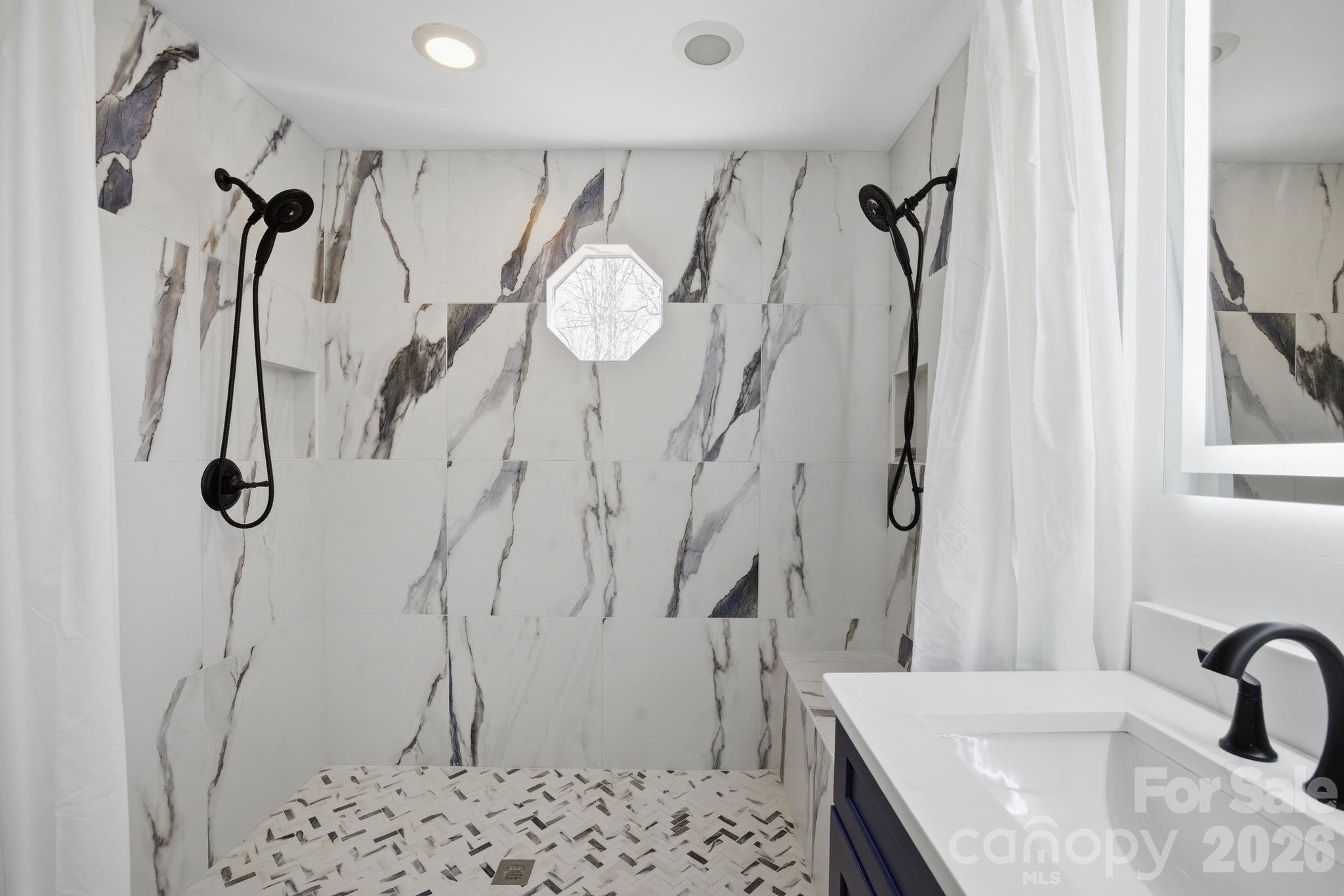 21326 Sandy Cove Road Cornelius, NC 28031 - Photo 11 of 21 a bathroom with a sink mirror and shower