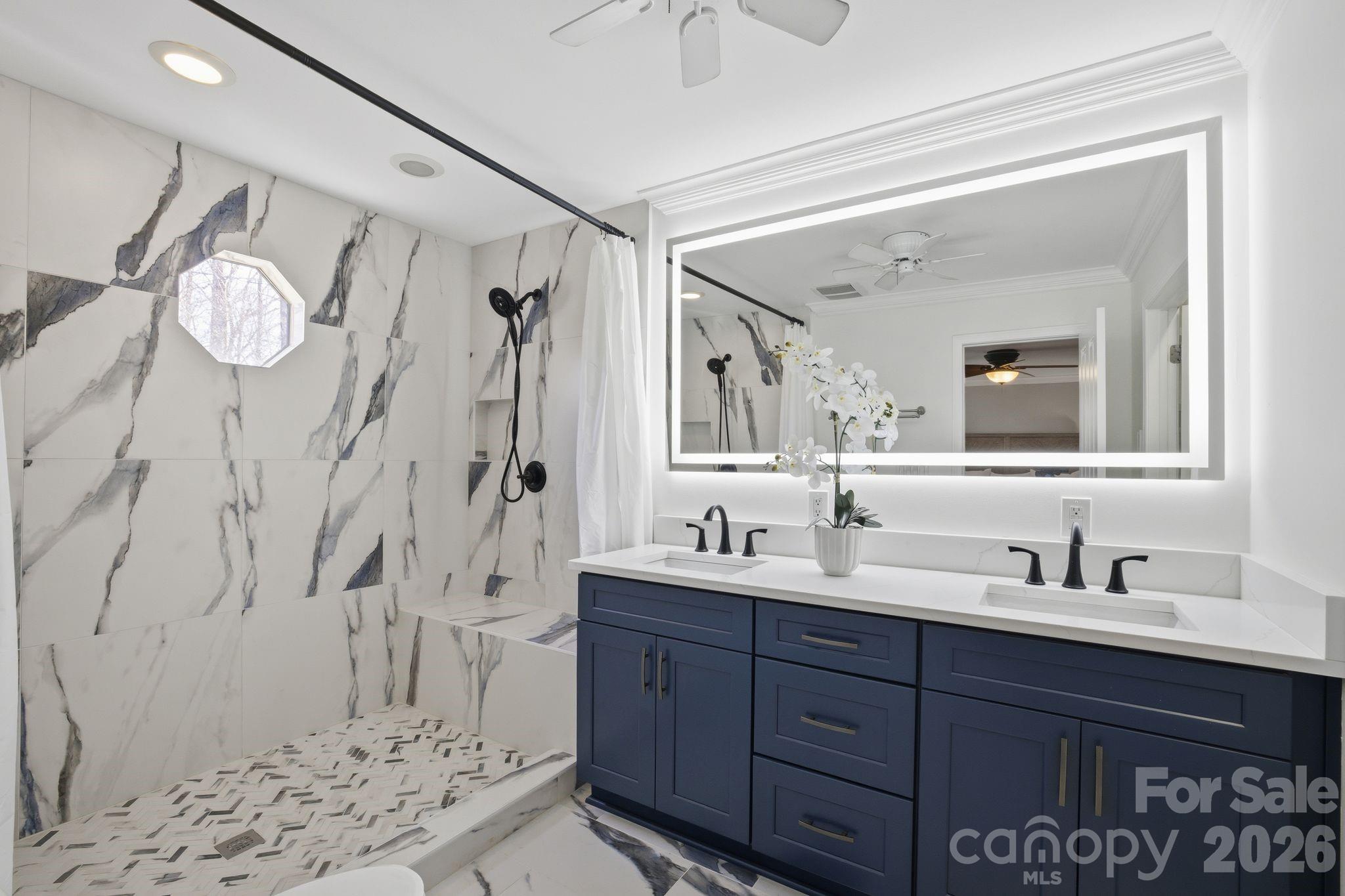 21326 Sandy Cove Road Cornelius, NC 28031 - Photo 12 of 21 a bathroom with a double vanity sink mirror and shower