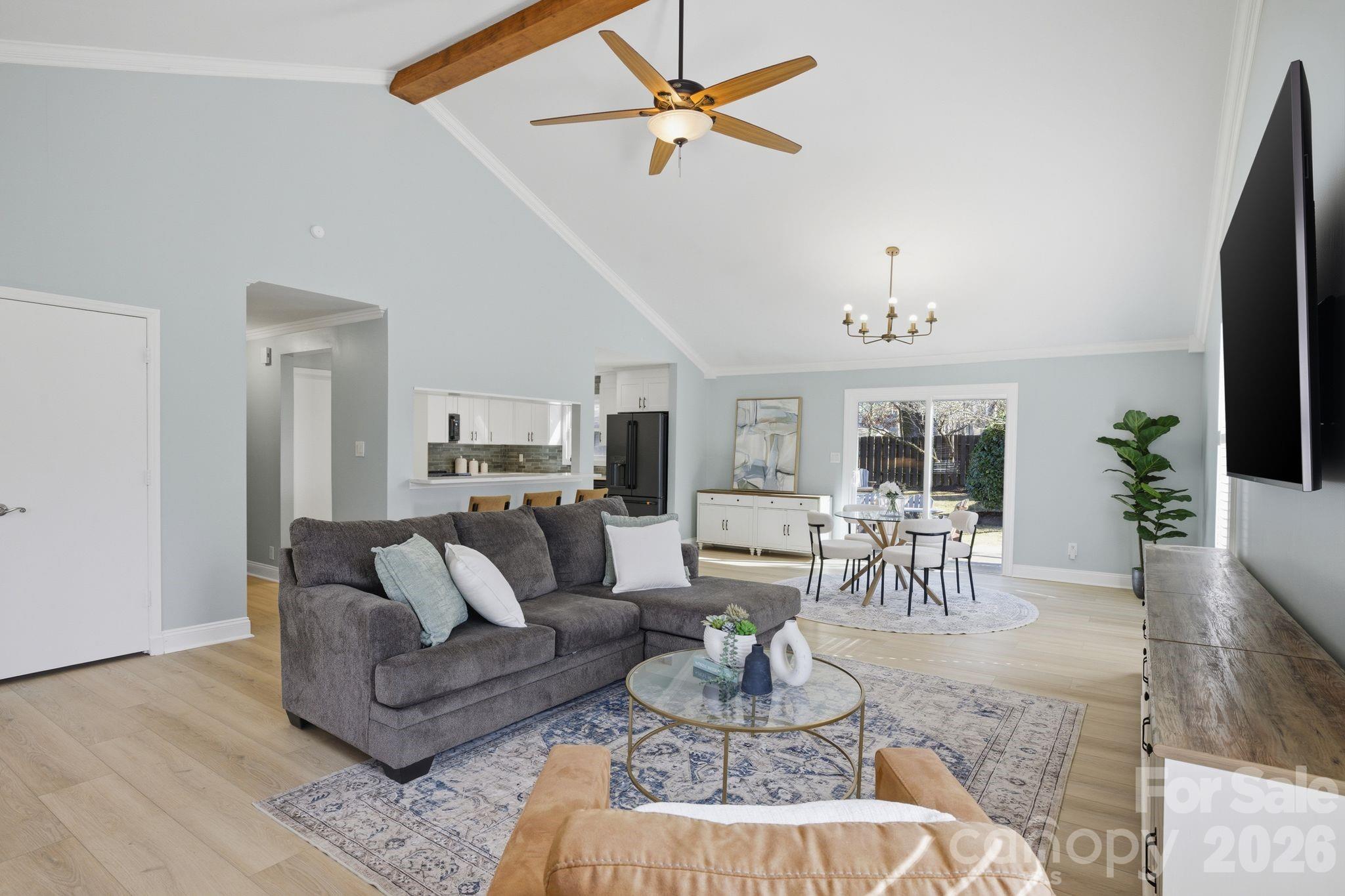 21326 Sandy Cove Road Cornelius, NC 28031 - Photo 4 of 21 a living room with furniture a dining table and a fireplace