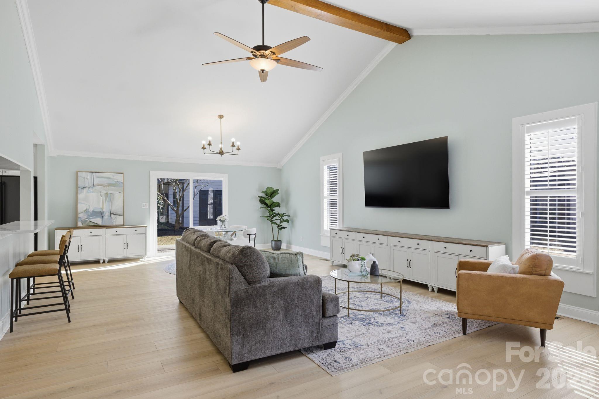 21326 Sandy Cove Road Cornelius, NC 28031 - Photo 5 of 21 a living room with furniture and a flat screen tv