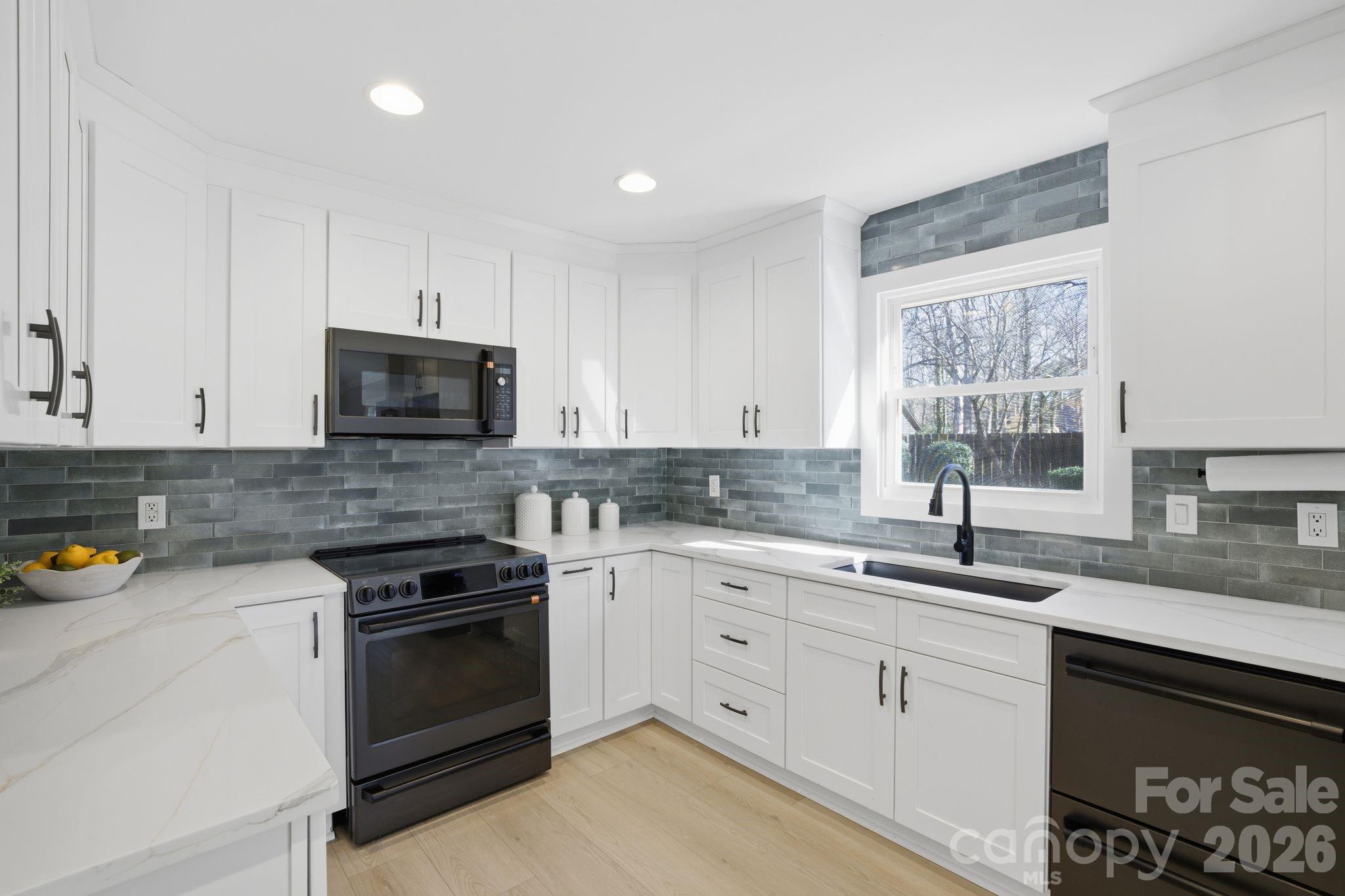 21326 Sandy Cove Road Cornelius, NC 28031 - Photo 8 of 21 a kitchen with a sink stove and cabinets