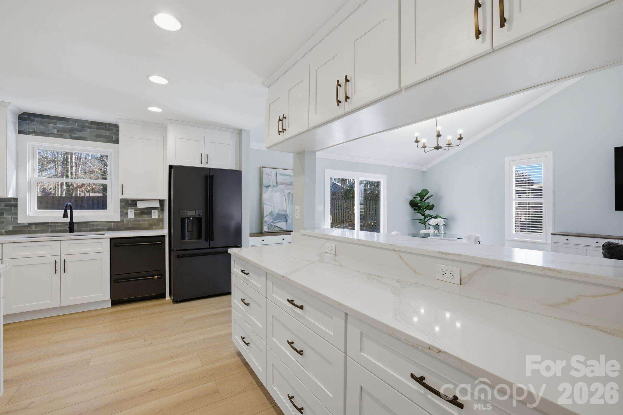 21326 Sandy Cove Road Cornelius, NC 28031 - Photo 9 of 21 a kitchen with a refrigerator and a sink