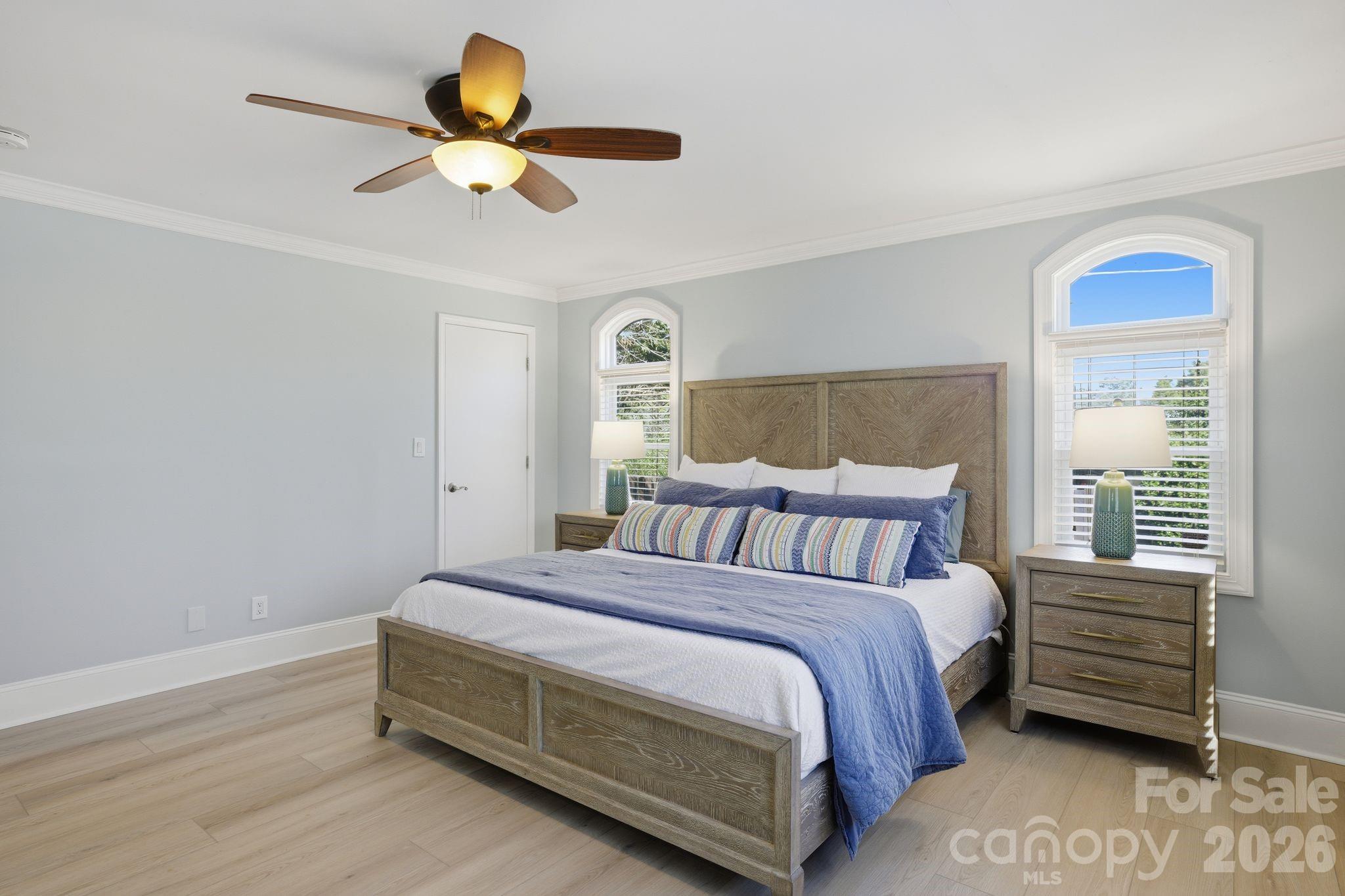 21326 Sandy Cove Road Cornelius, NC 28031 - Photo 10 of 21 a bedroom with a bed and a chandelier