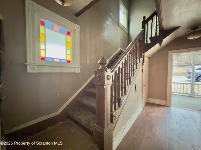 a view of a livingroom with wooden floor and a window