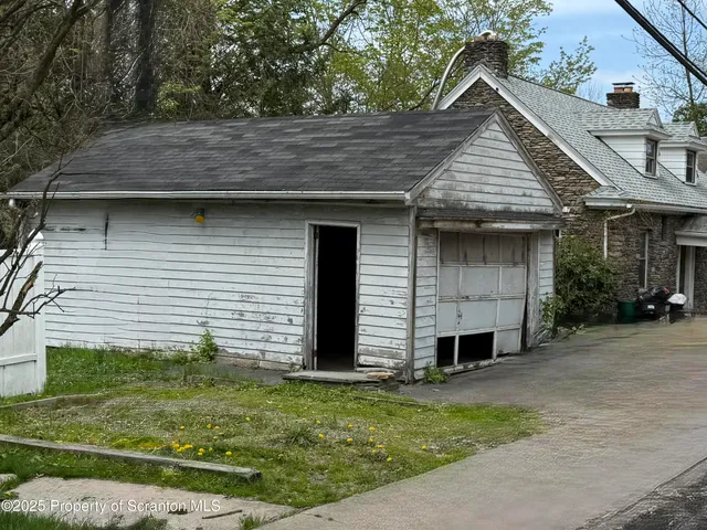 a view of an empty room with glass door and wooden floor