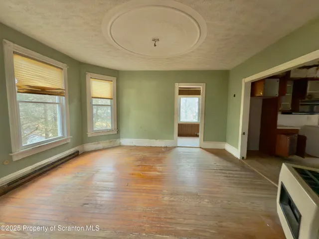 a view of a kitchen with kitchen island a sink and wooden floor