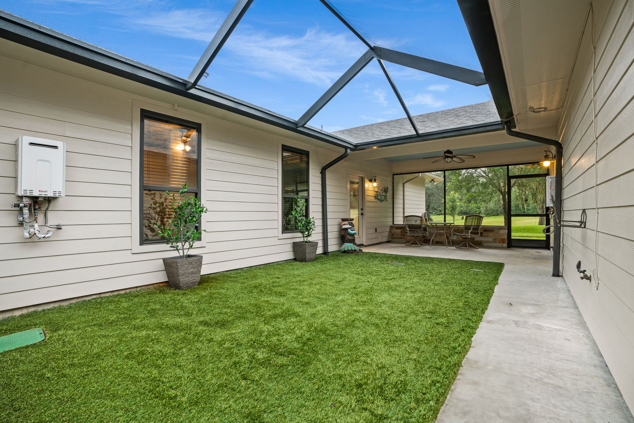 1114 Star Ridge Road Weimar, TX 78962 - Photo 5 of 50 Screen Enclosed Breezeway with Artificial Turf and Drainage system.