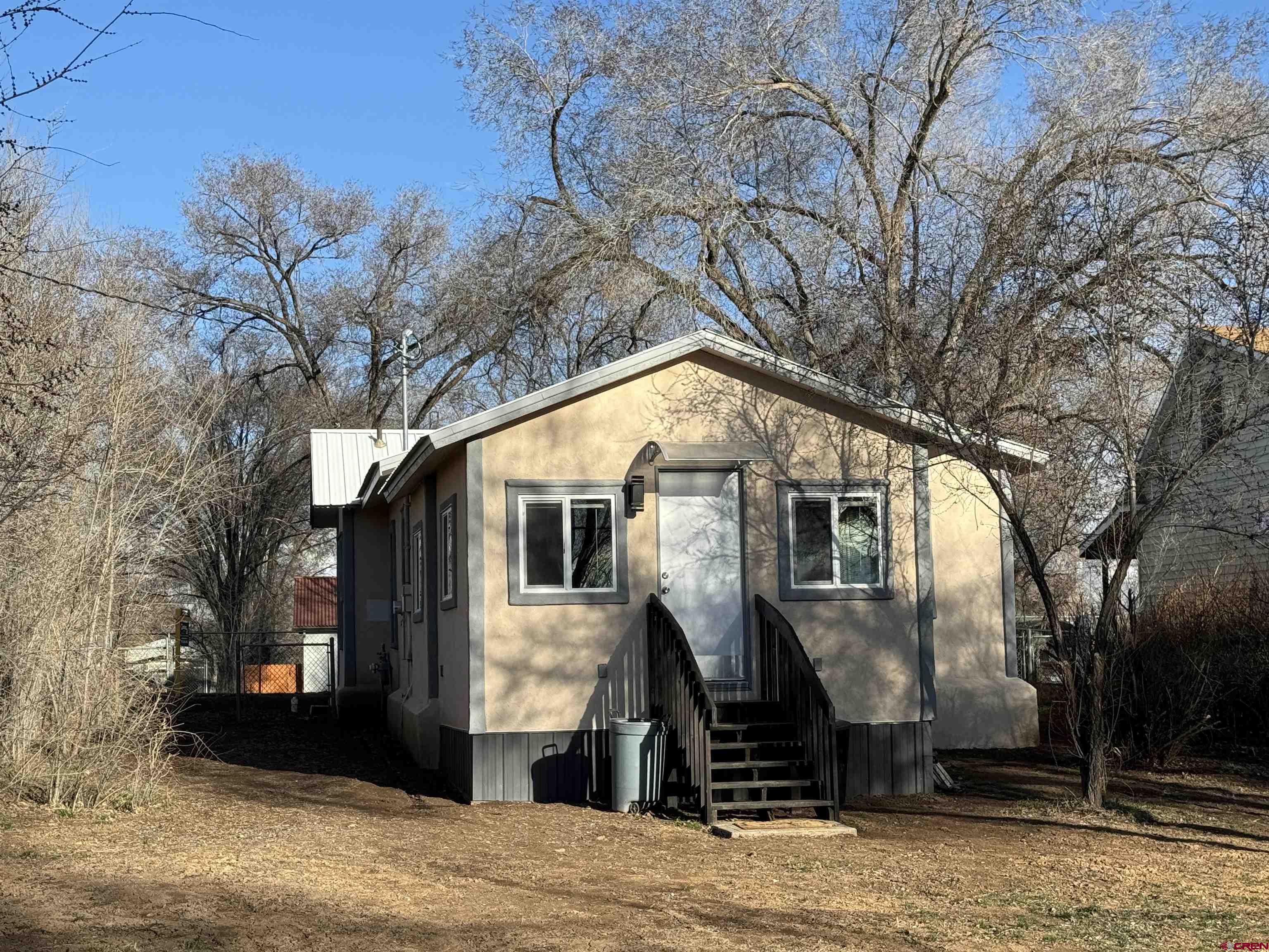 121 South Washington Street Cortez, CO 81321 - Photo 15 of 33 a front view of a house with a yard