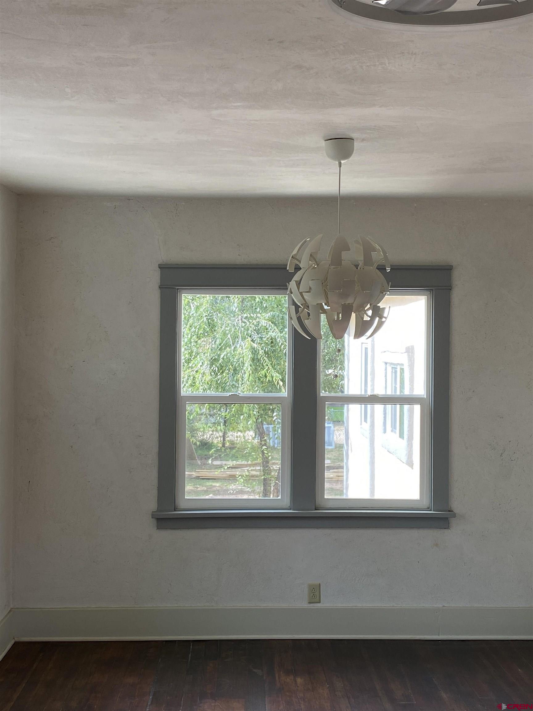 121 South Washington Street Cortez, CO 81321 - Photo 20 of 33 a bathroom with a window and a chandelier