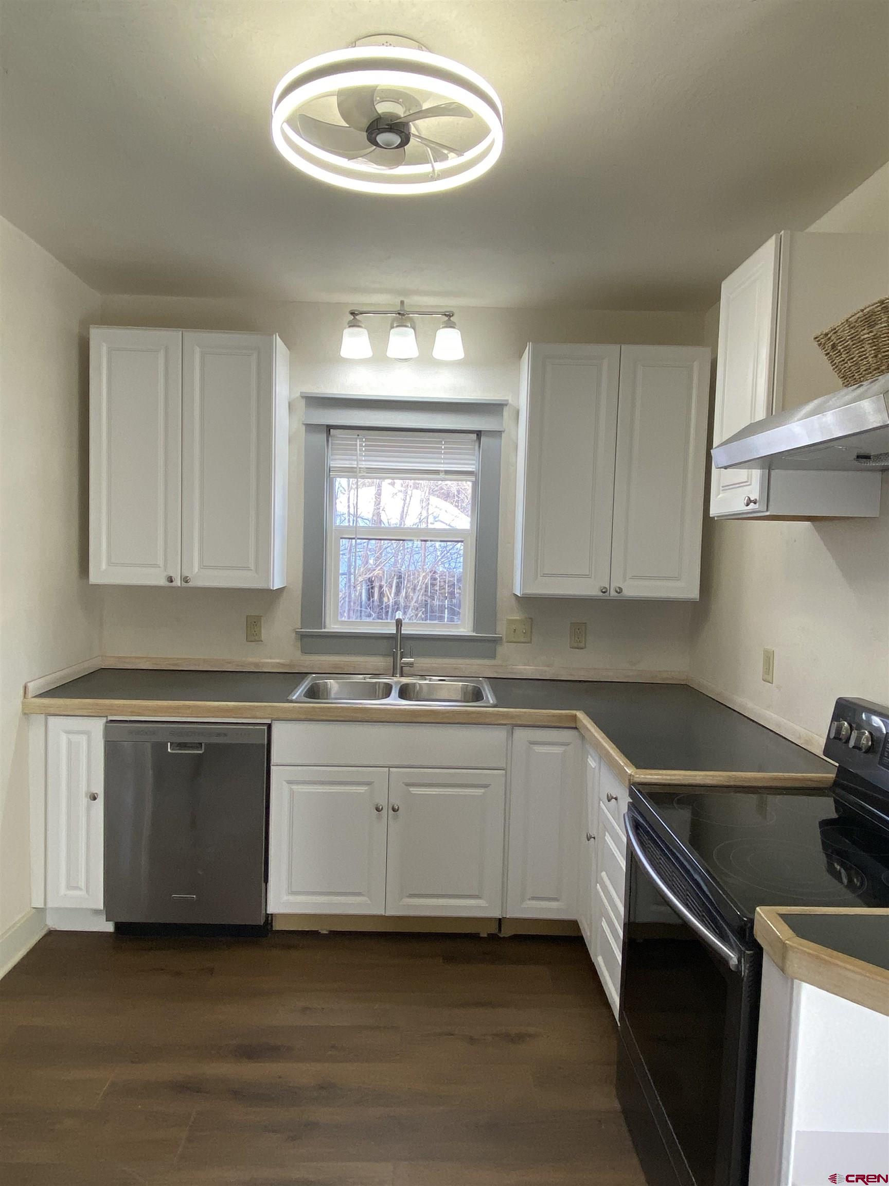 121 South Washington Street Cortez, CO 81321 - Photo 2 of 33 a kitchen with a sink stove and cabinets