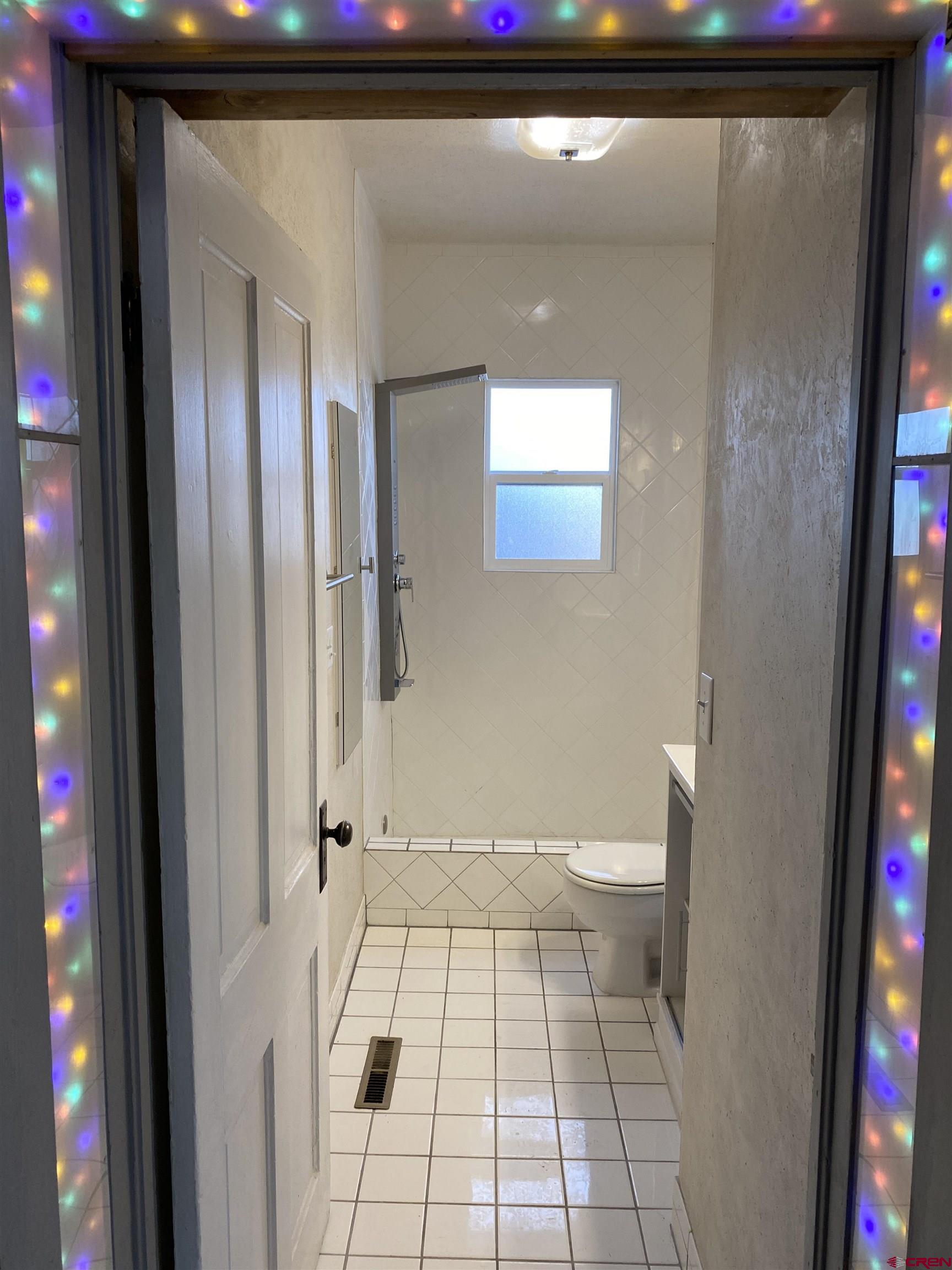 121 South Washington Street Cortez, CO 81321 - Photo 23 of 33 a bathroom with a toilet and a shower