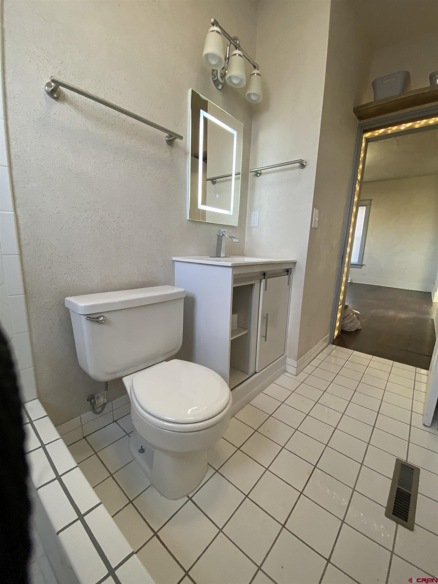 121 South Washington Street Cortez, CO 81321 - Photo 24 of 33 a bathroom with a toilet and a shower