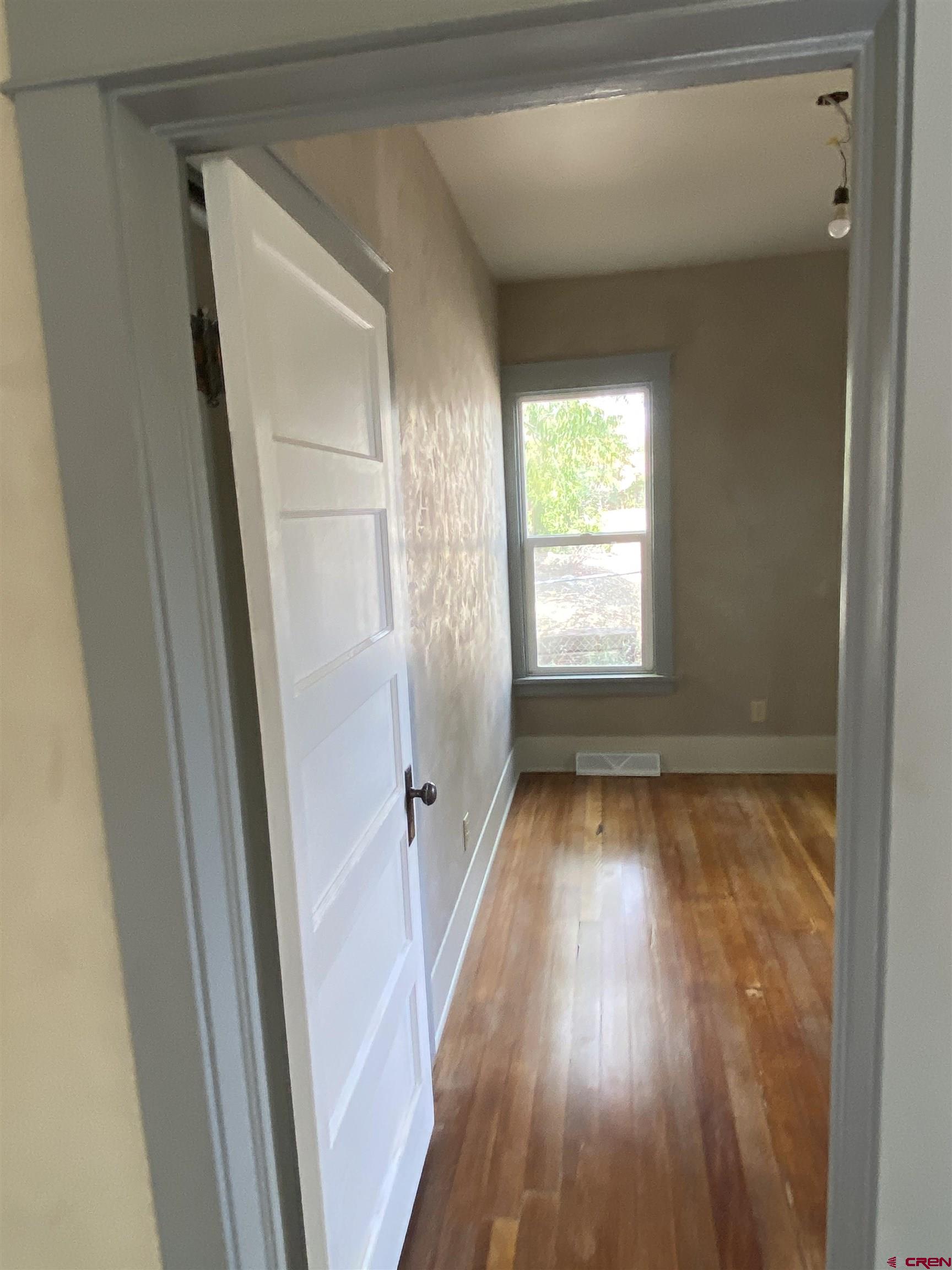 121 South Washington Street Cortez, CO 81321 - Photo 26 of 33 a view of an empty room with wooden floor and a window