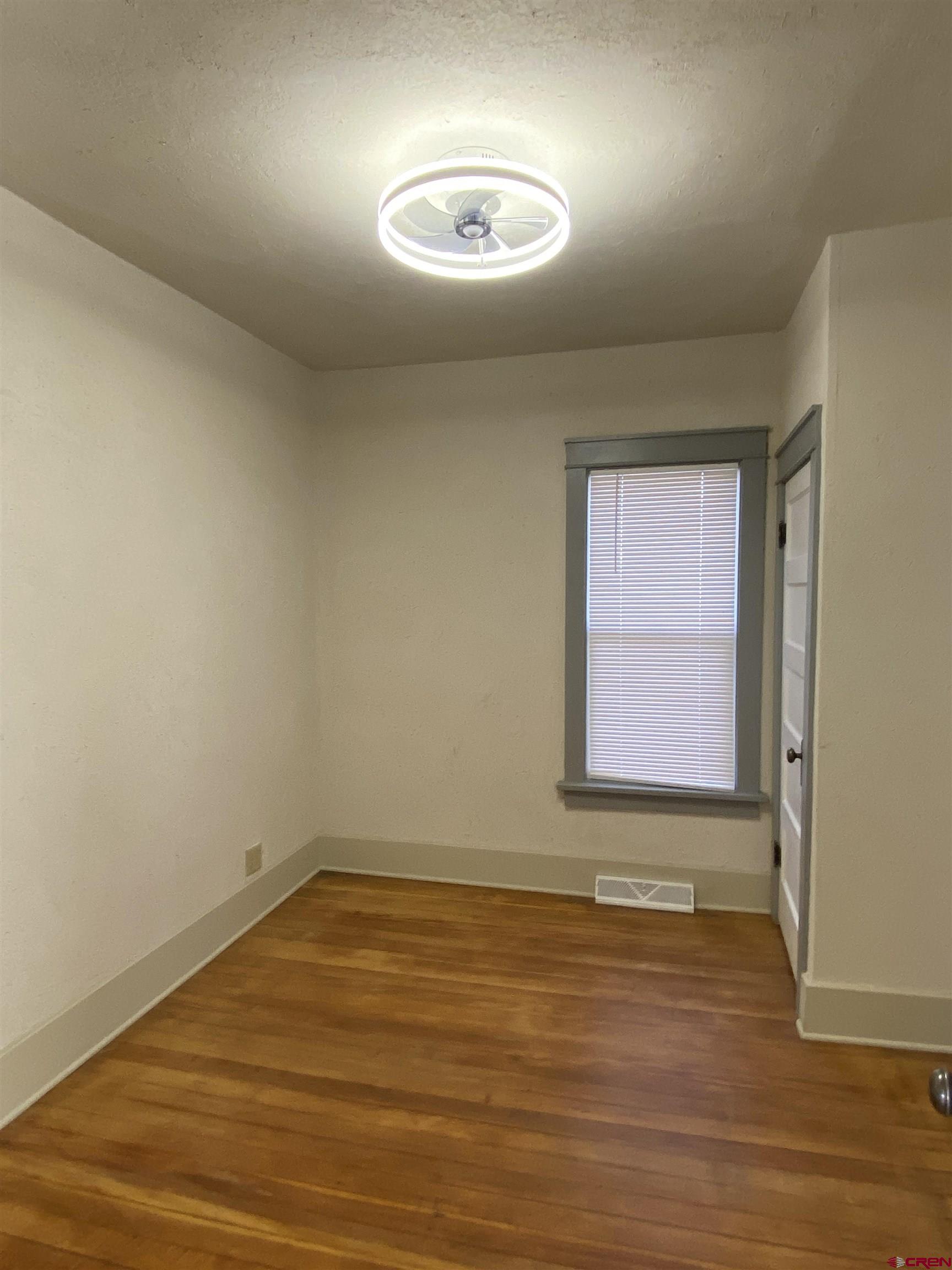 121 South Washington Street Cortez, CO 81321 - Photo 27 of 33 a view of empty room with wooden floor