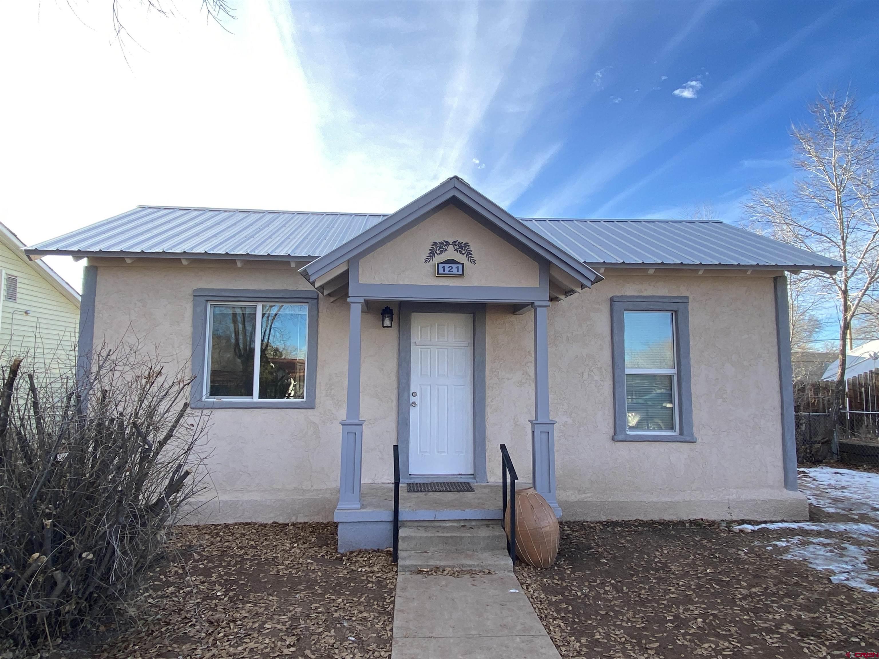 121 South Washington Street Cortez, CO 81321 - Photo 32 of 33 a front view of a house with garden