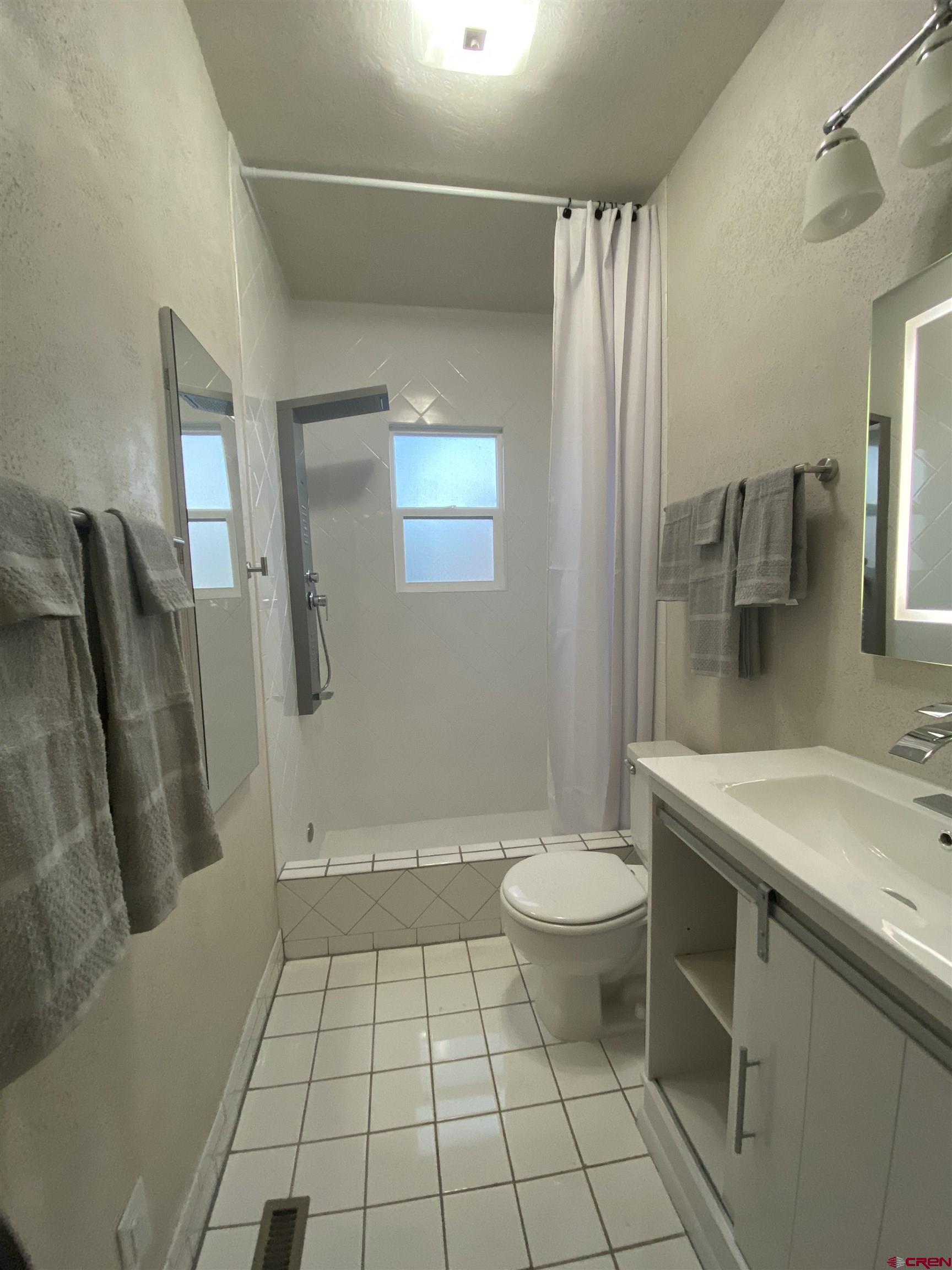 121 South Washington Street Cortez, CO 81321 - Photo 6 of 33 a bathroom with a sink a toilet and shower