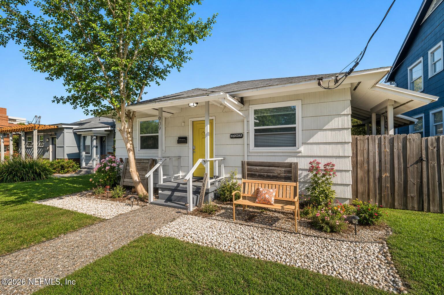 909 Cedar Street Jacksonville, FL 32207 - Photo 2 of 41 a view of a house with backyard sitting area and garden