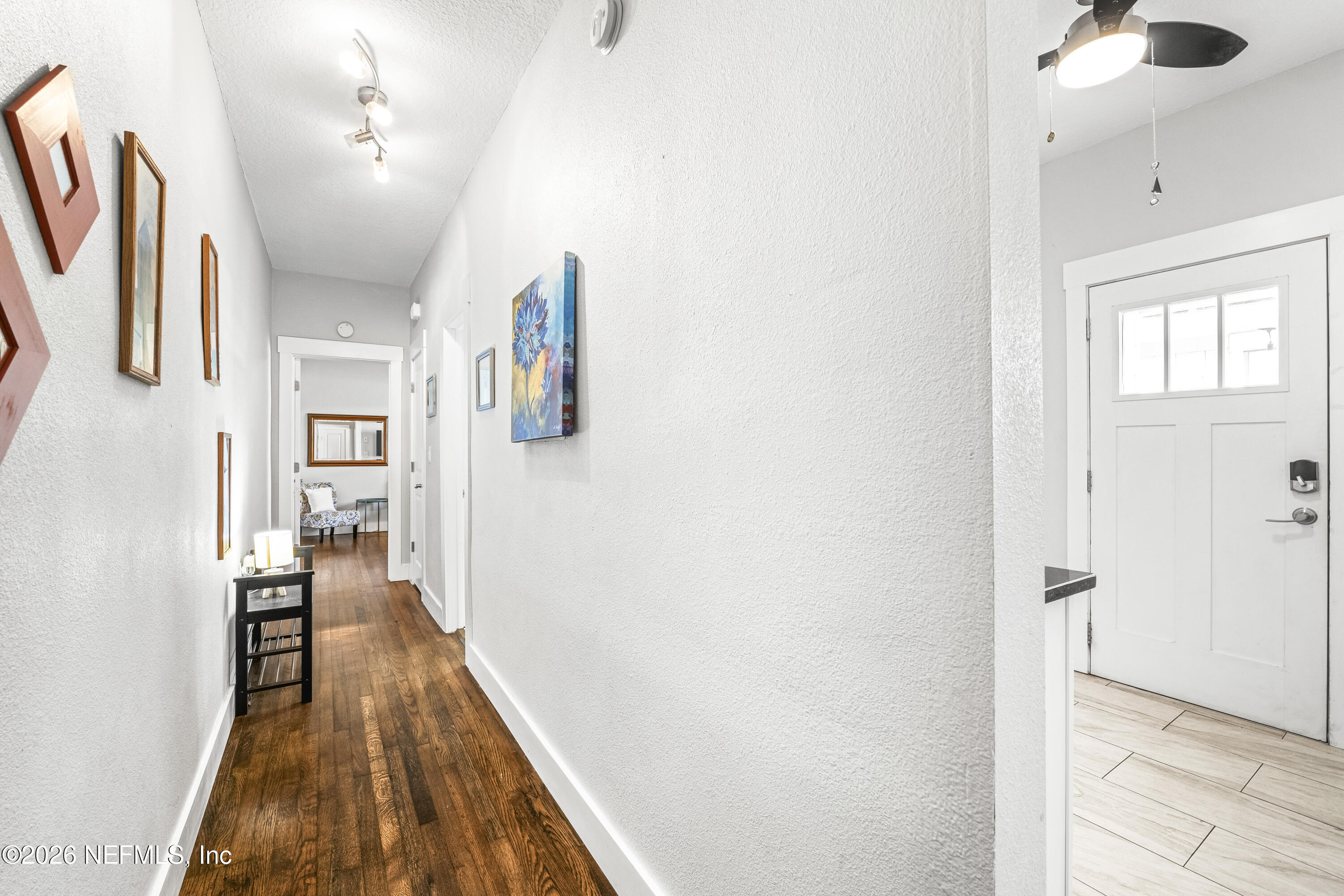 909 Cedar Street Jacksonville, FL 32207 - Photo 23 of 41 a view of a hallway with wooden floor and staircase