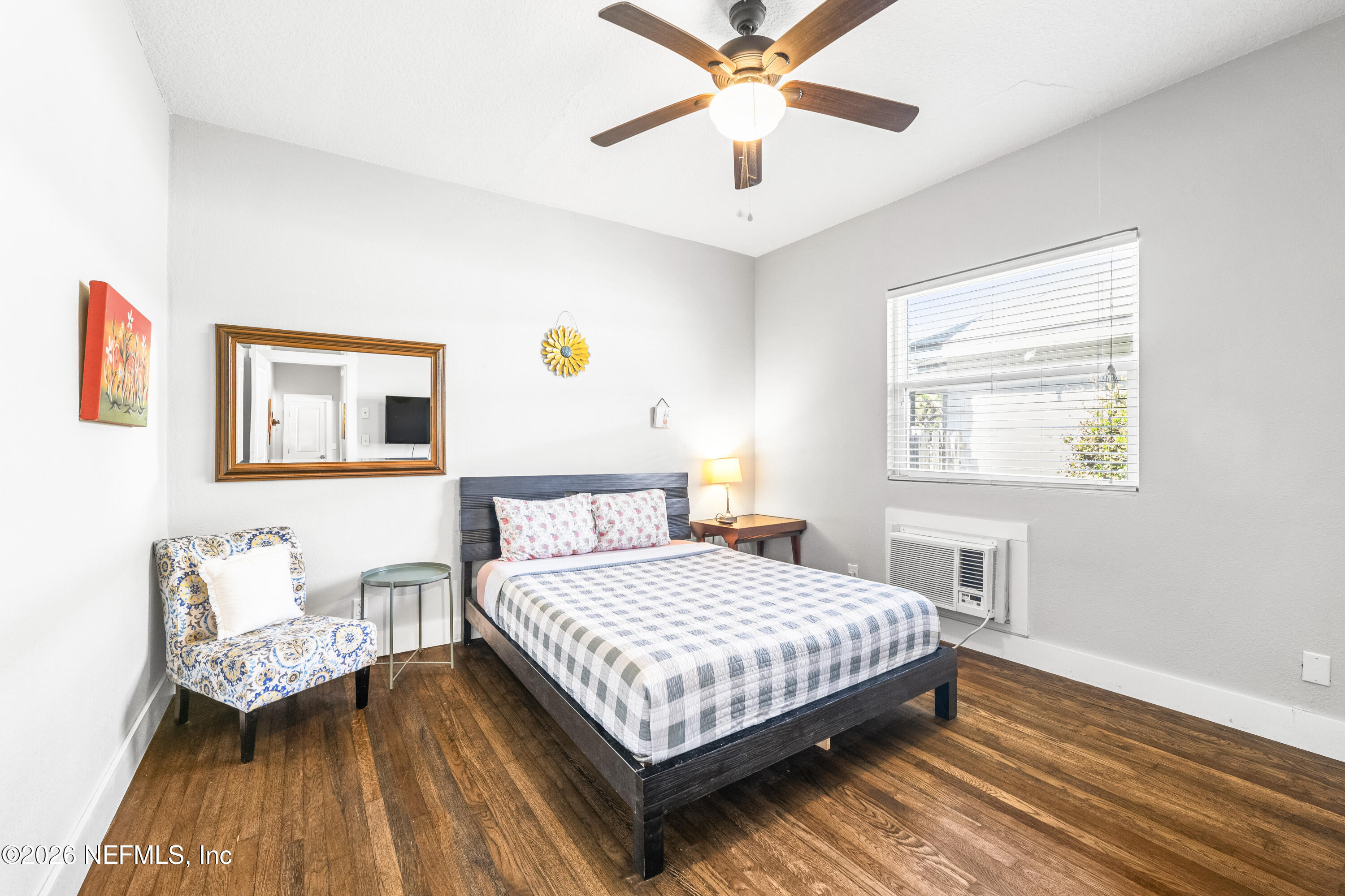 909 Cedar Street Jacksonville, FL 32207 - Photo 24 of 41 a bedroom with a bed and a chandelier