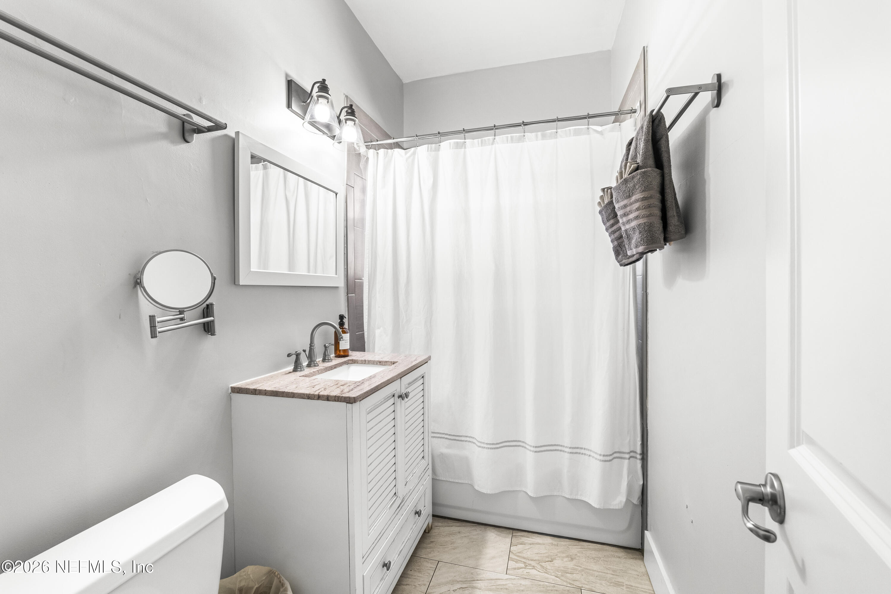 909 Cedar Street Jacksonville, FL 32207 - Photo 26 of 41 a bathroom with a sink a toilet and shower
