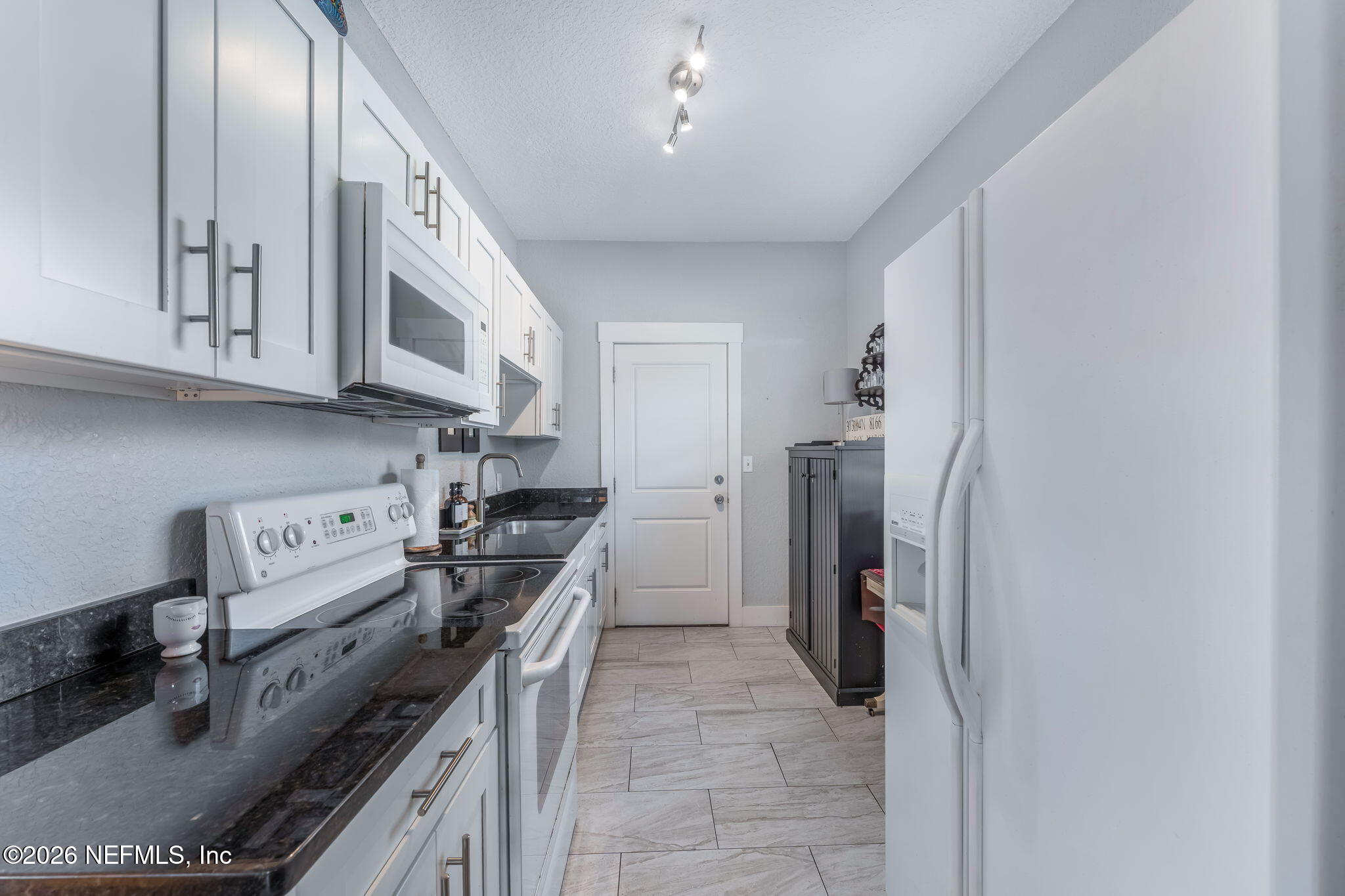 909 Cedar Street Jacksonville, FL 32207 - Photo 7 of 41 a kitchen with stainless steel appliances granite countertop a stove and a refrigerator