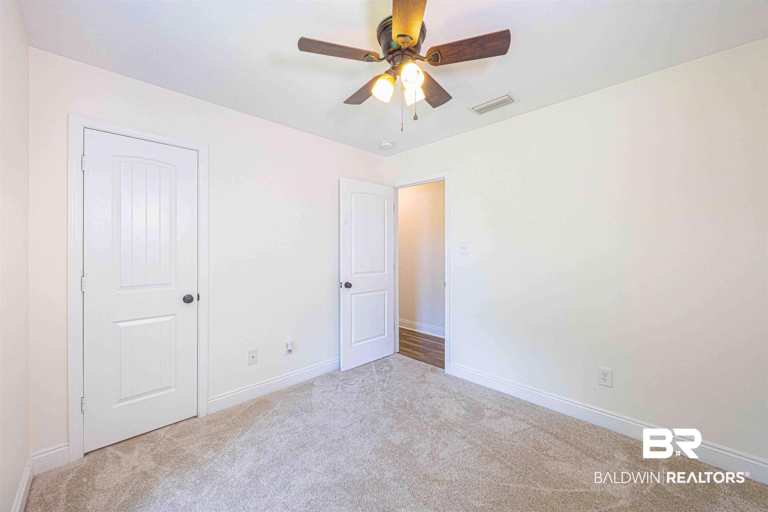 18675 Explorer Drive Loxley, AL 36551 - Photo 32 of 42 Unfurnished bedroom featuring carpet floors, baseboards, and ceiling fan