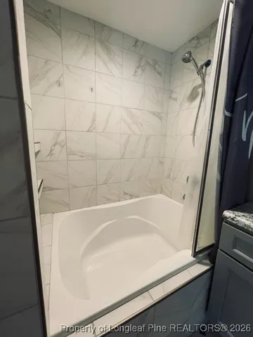 a bathroom with a white bath tub