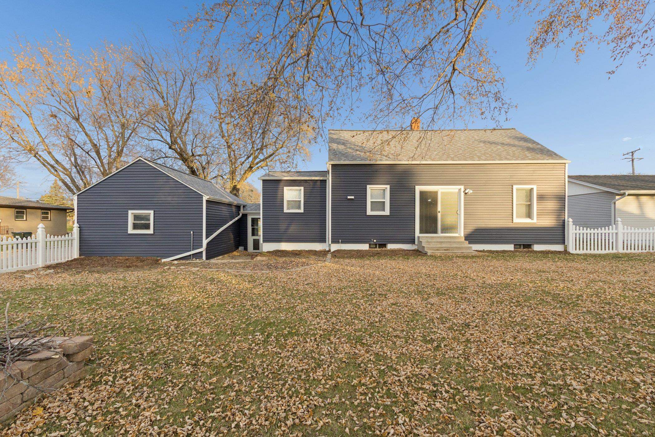 519 South Sycamore Street Genoa, IL 60135 - Photo 33 of 36 a house with trees in front of it