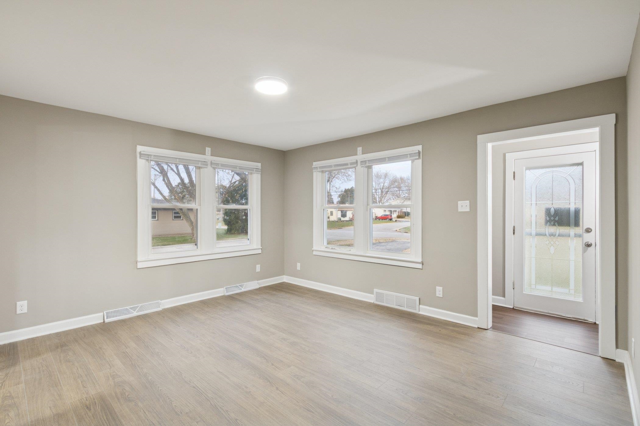 519 South Sycamore Street Genoa, IL 60135 - Photo 4 of 36 an empty room with windows and closet