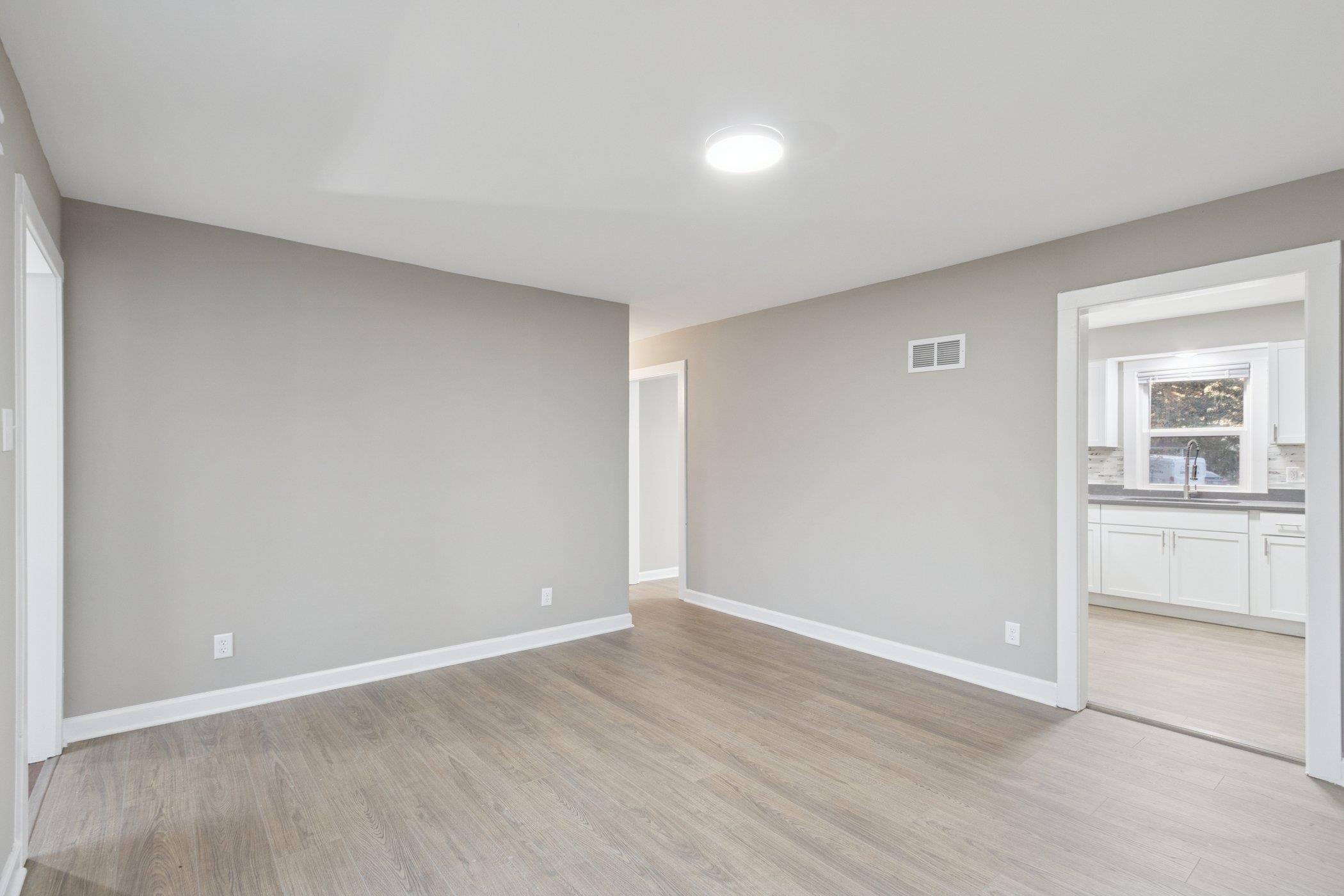 519 South Sycamore Street Genoa, IL 60135 - Photo 5 of 36 a view of an empty room with a window
