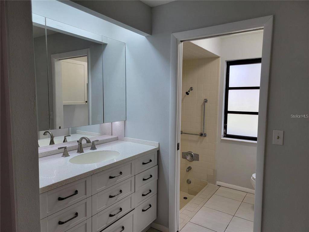 26221 Constantine Road Punta Gorda, FL 33983 - Photo 10 of 27 a bathroom with a double vanity sink and mirror