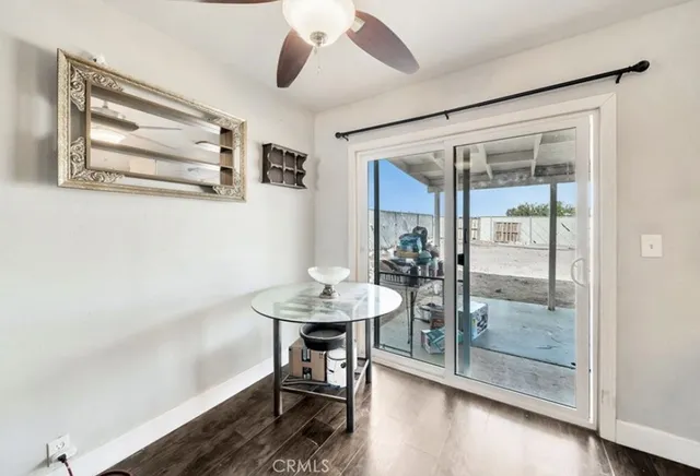 a view of a room with furniture and wooden floor