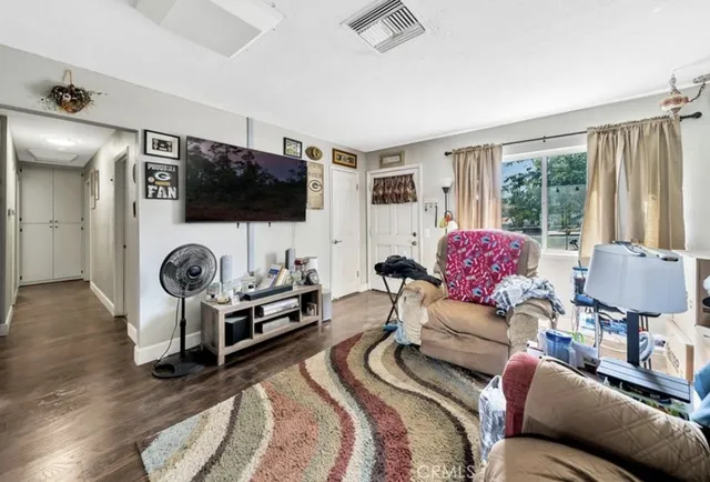 a bedroom with furniture and a flat screen tv