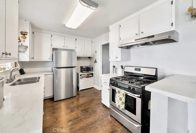 a kitchen with cabinets and stainless steel appliances