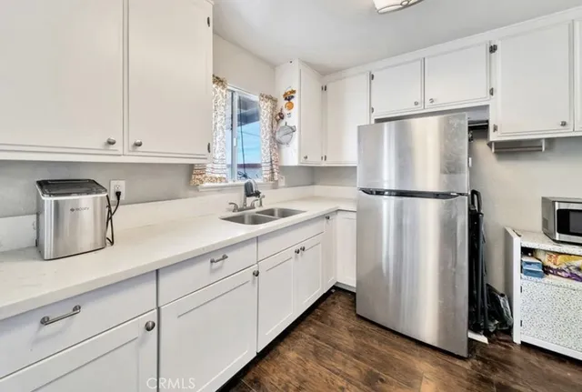 a kitchen with refrigerator and cabinets