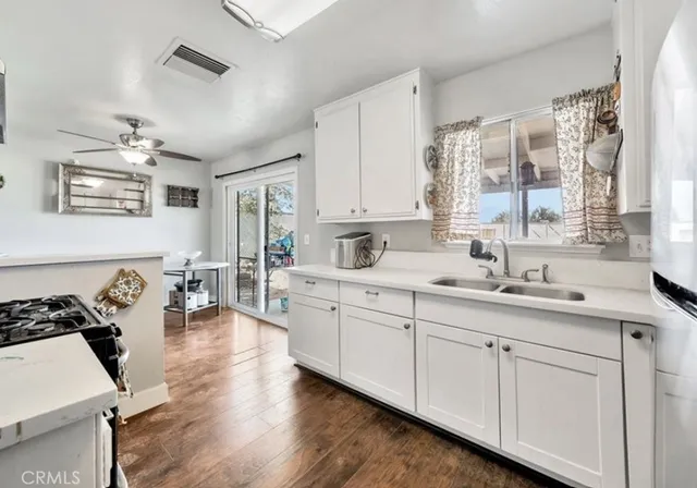 a kitchen with a sink stove and cabinets