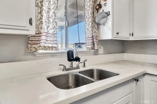 a kitchen with a sink and cabinets