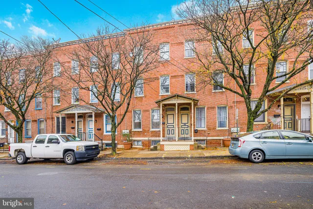 a view of a building with cars parked in front of it