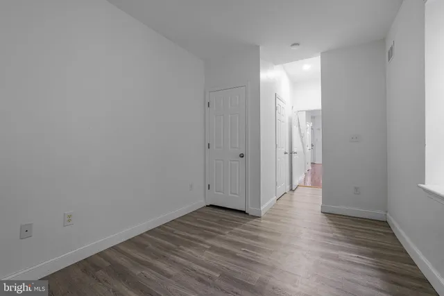 a view of a room with wooden floor