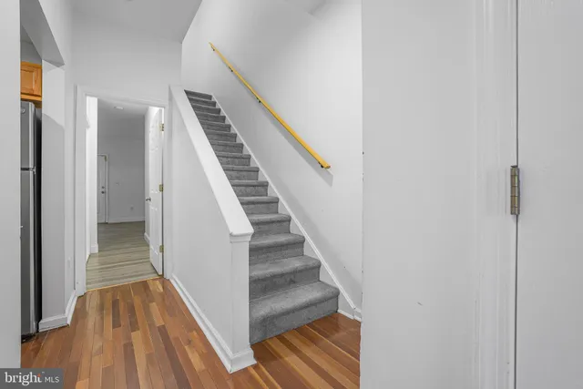 a view of a hallway with wooden floor and entryway