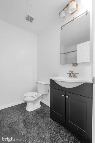 a bathroom with a sink toilet and vanity