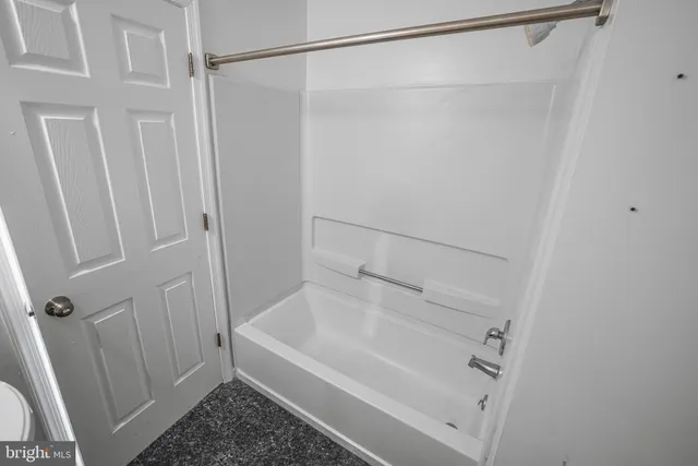 a bathroom with a shower and a bath tub