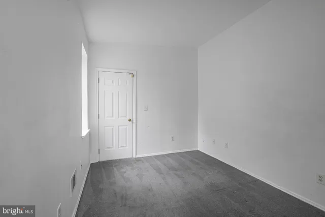 an empty room with closet area