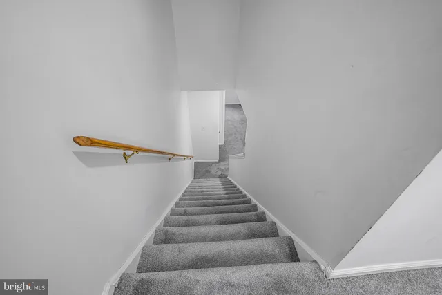 a view of staircase with white walls